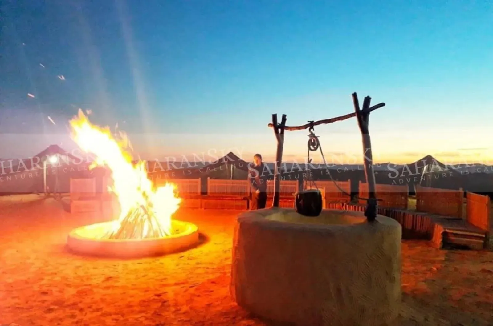 The fire pit at the desert camp lit after dark