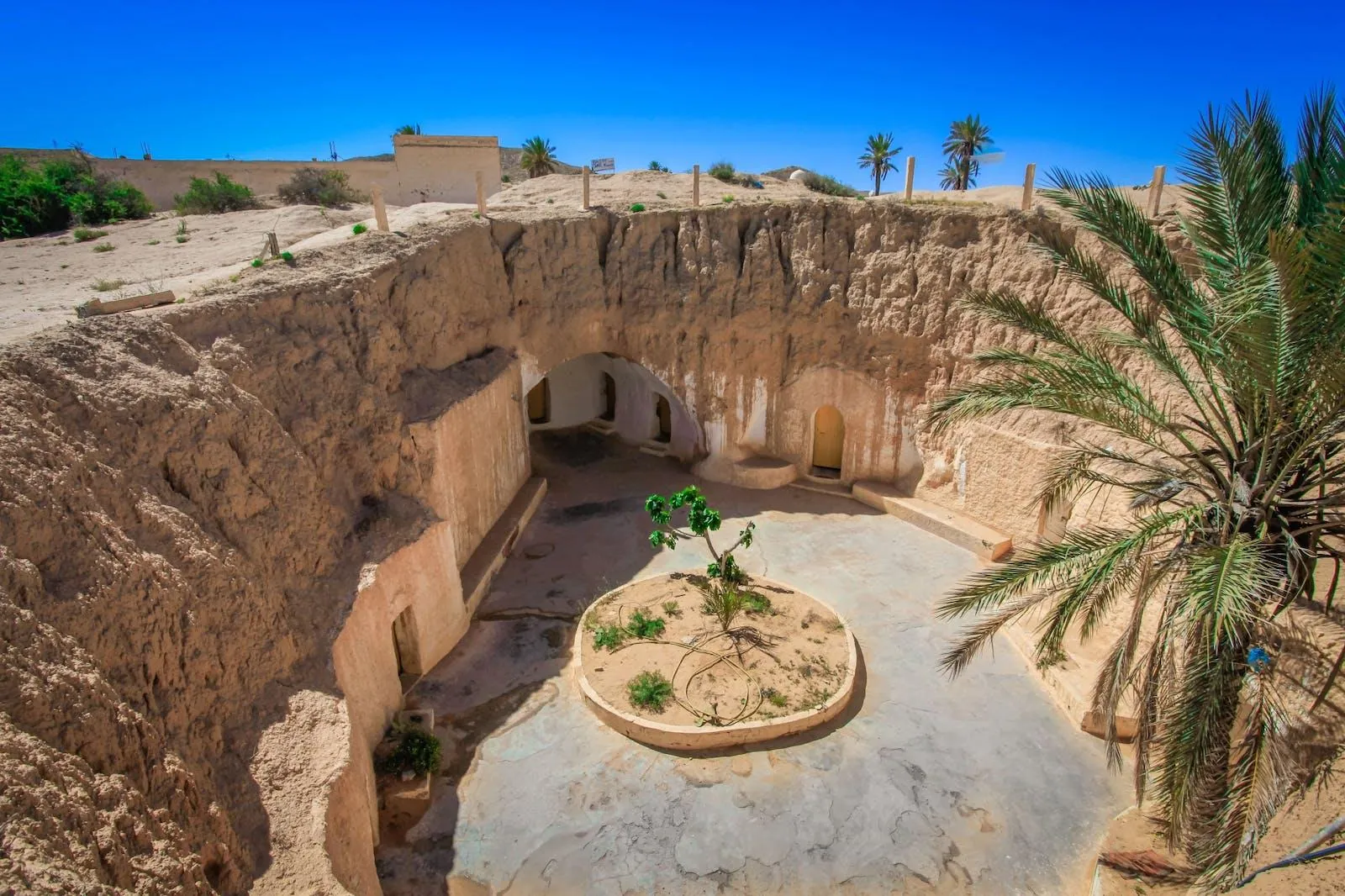 A courtyard pit house at Matmata with a palm growing in the middle