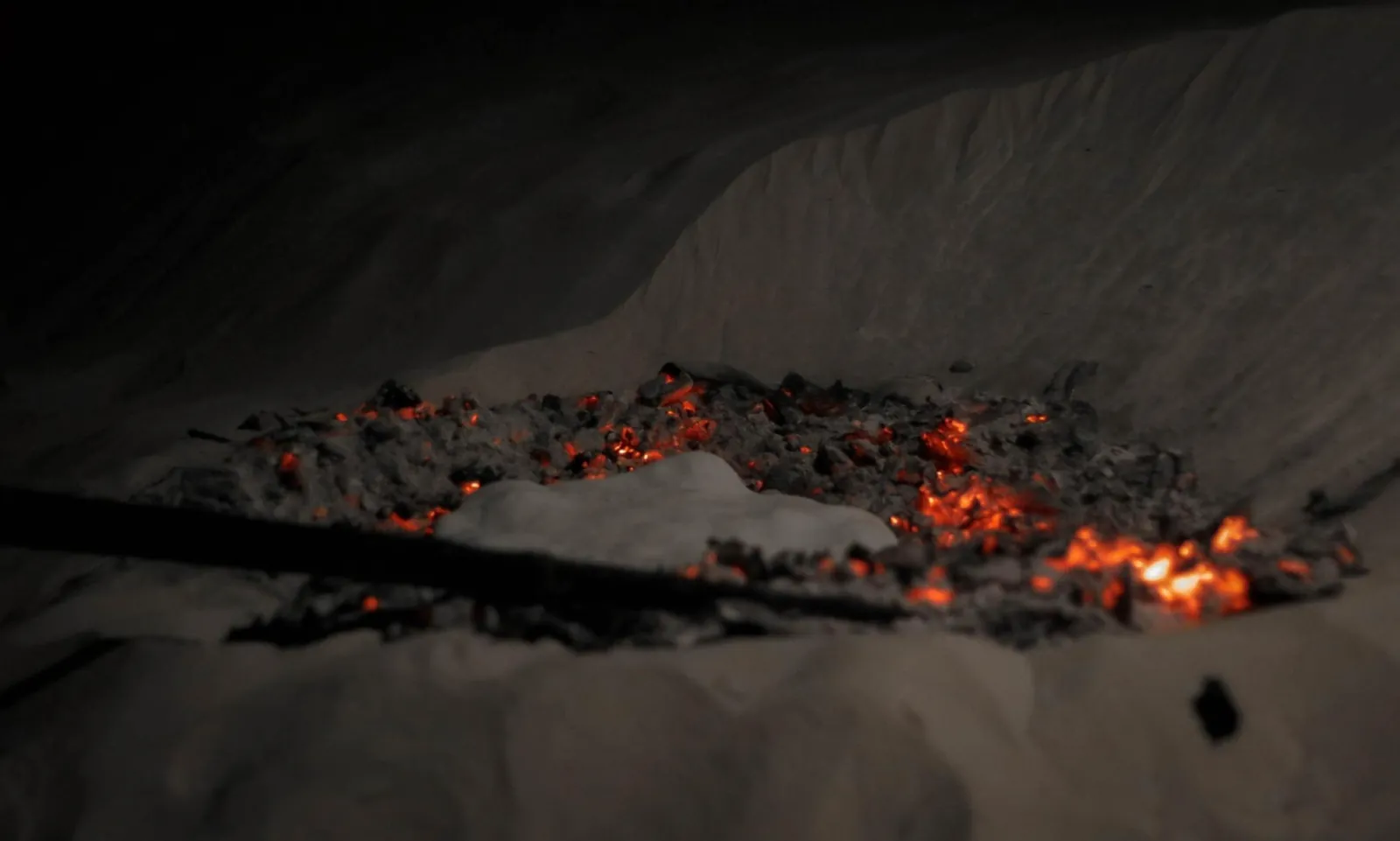 Flatbread baking in the embers of a desert fire